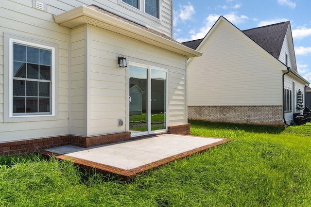 exterior space featuring a patio area and a lawn