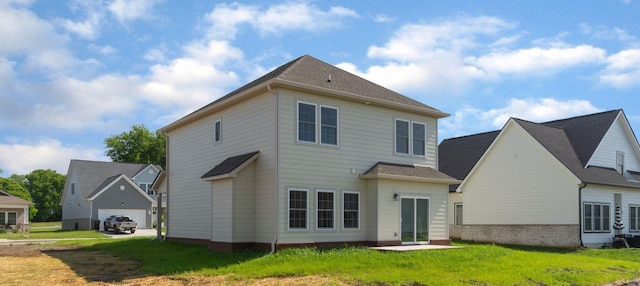 back of house with a lawn