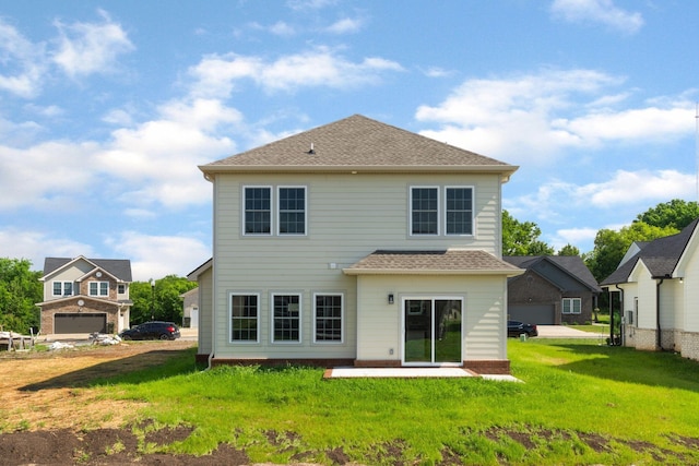 back of house with a yard and a patio