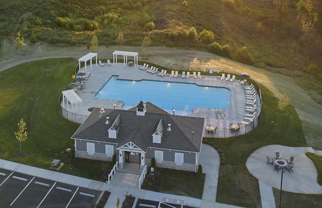 view of pool with a yard, a patio area, and a pergola