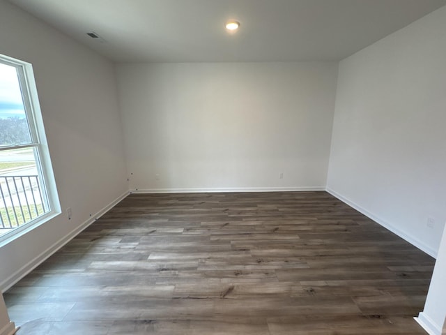 unfurnished room with dark hardwood / wood-style floors