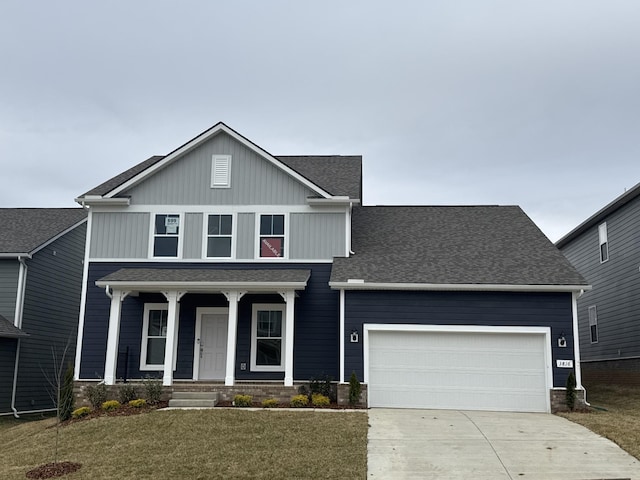 view of front facade featuring a garage, a porch, and a front yard