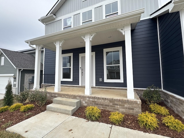 property entrance with a garage and a porch