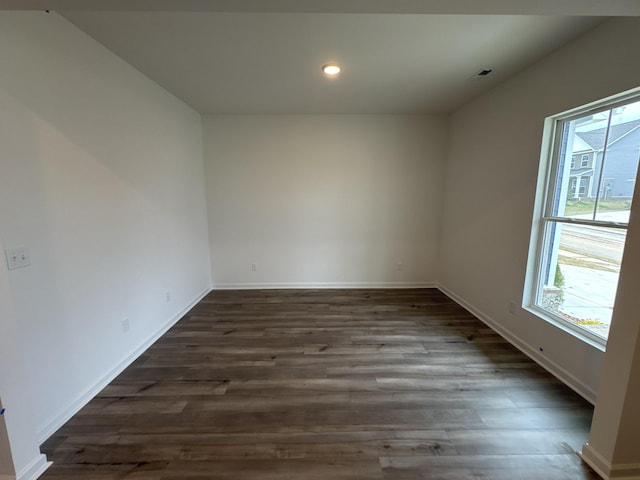 spare room with dark wood-type flooring