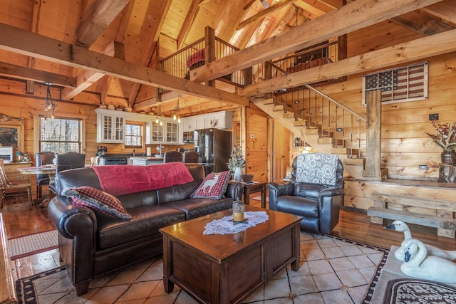 living room featuring wood ceiling, wooden walls, high vaulted ceiling, and beam ceiling