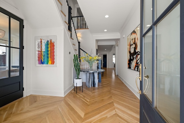 foyer featuring parquet flooring and ornamental molding