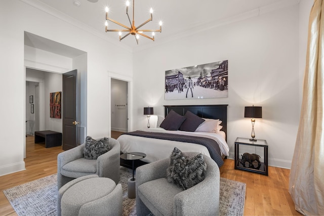 bedroom with wood-type flooring, a chandelier, and crown molding