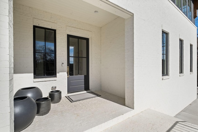 property entrance featuring a patio area