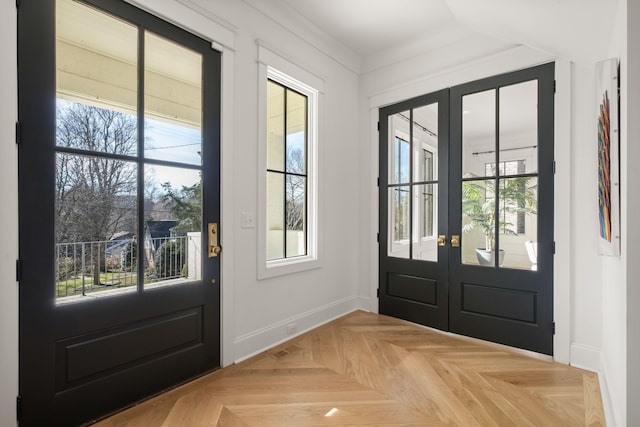 doorway to outside featuring light parquet floors and french doors