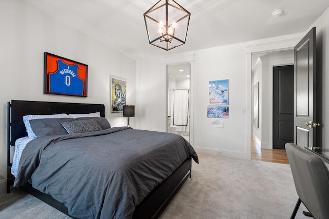 bedroom with light carpet and an inviting chandelier