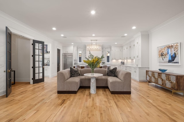 living room with ornamental molding and light wood-type flooring