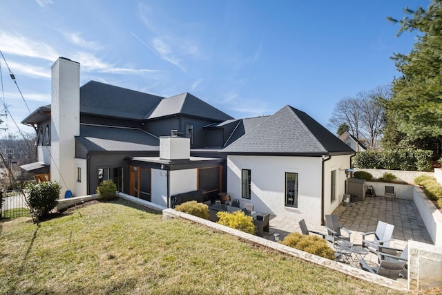 back of house featuring a lawn and a patio area