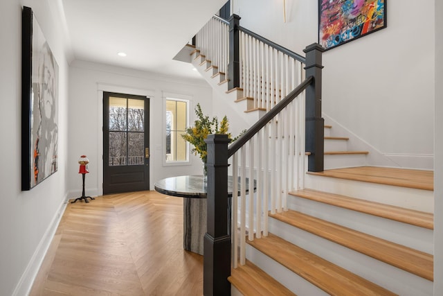 entryway featuring ornamental molding and light parquet floors