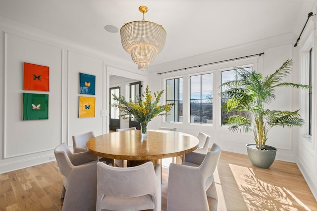 dining room featuring a notable chandelier and light hardwood / wood-style flooring