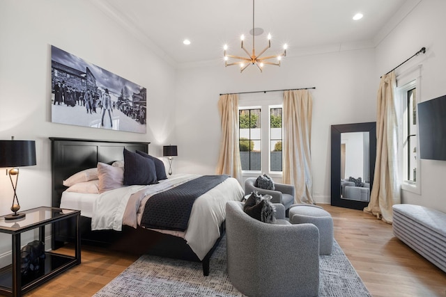 bedroom featuring crown molding, a chandelier, and light hardwood / wood-style floors