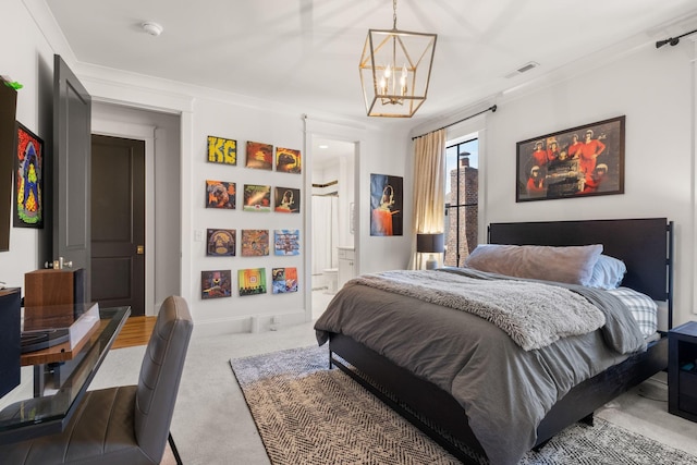 carpeted bedroom featuring ensuite bath, ornamental molding, and a notable chandelier