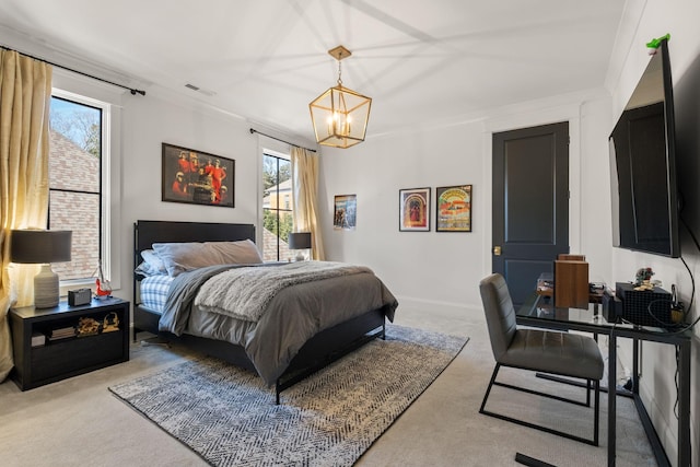 carpeted bedroom with crown molding and a chandelier