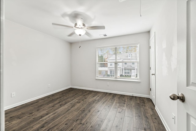 empty room with ceiling fan and dark hardwood / wood-style floors