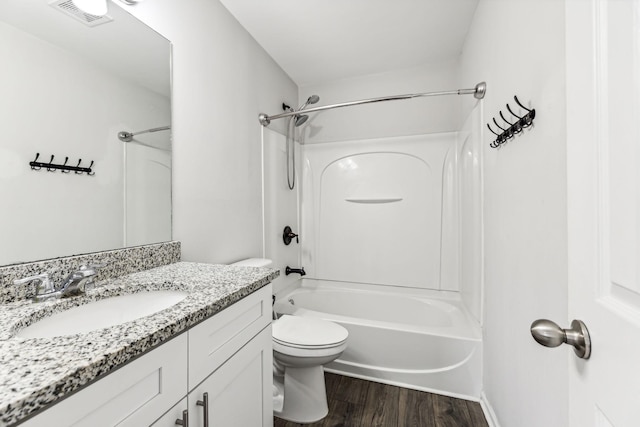 full bathroom with vanity, hardwood / wood-style floors,  shower combination, and toilet