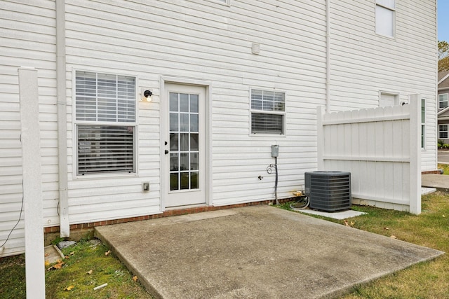 entrance to property with cooling unit and a patio