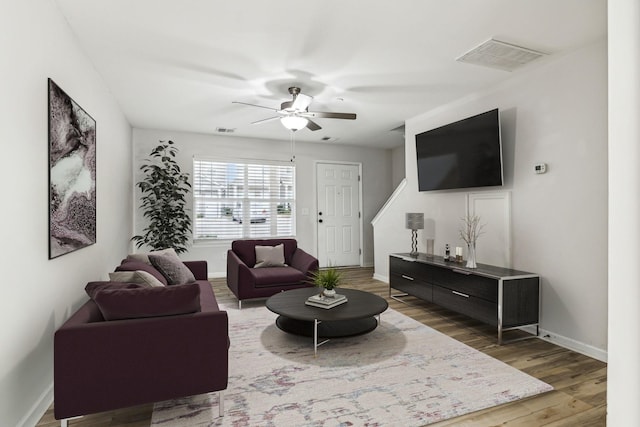 living room with hardwood / wood-style floors and ceiling fan