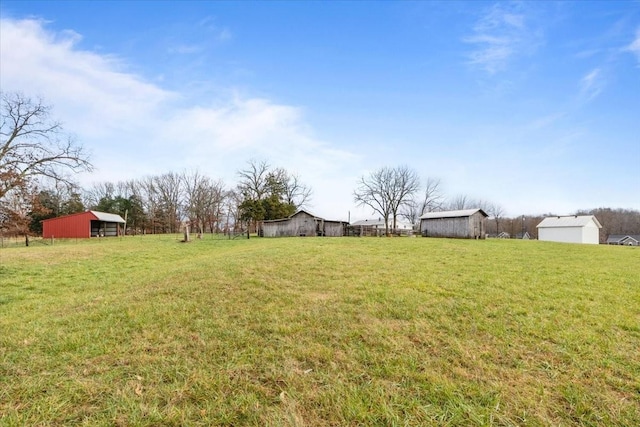 view of yard with an outbuilding and a rural view