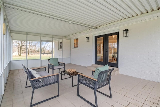 sunroom / solarium featuring french doors