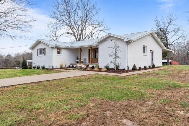 single story home with a front yard and covered porch