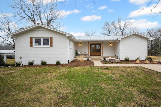 single story home featuring french doors, a porch, and a front lawn