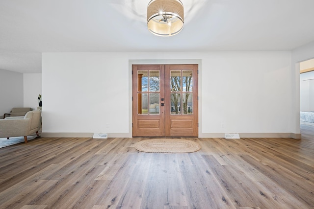 entryway featuring french doors and light wood-type flooring