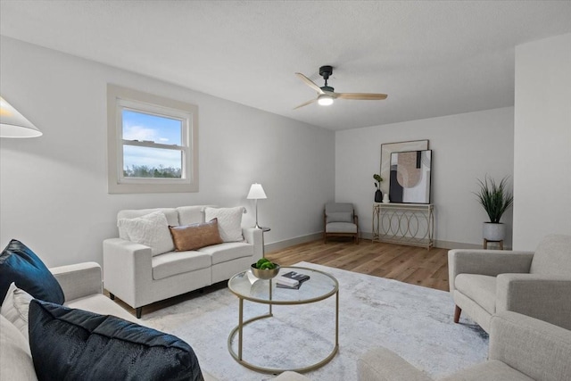 living room featuring light hardwood / wood-style floors and ceiling fan