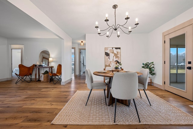 dining room with an inviting chandelier and wood-type flooring