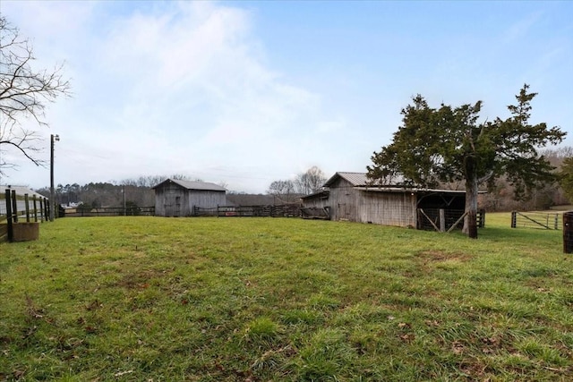 view of yard featuring an outdoor structure and a rural view