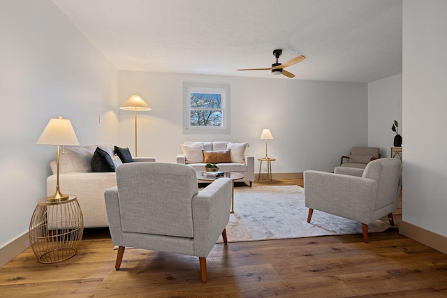 living room with hardwood / wood-style floors and ceiling fan