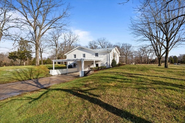 view of side of property featuring a yard and a carport