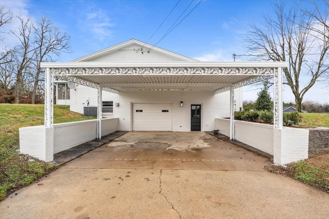 view of home's exterior with cooling unit, a garage, and a carport