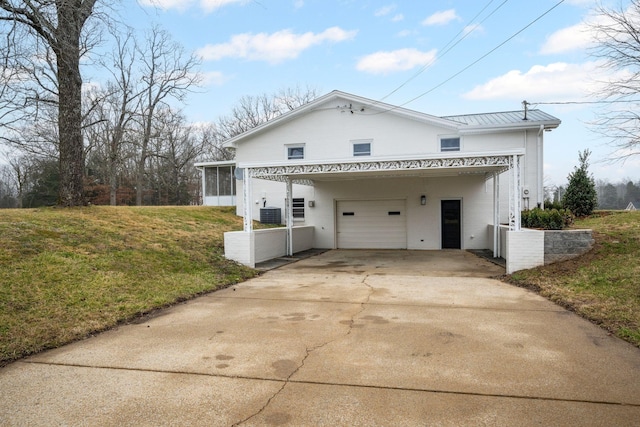 back of house with a yard, a sunroom, a carport, and central air condition unit