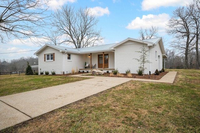 ranch-style house with a front yard and covered porch