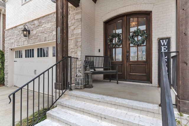 property entrance with a garage and french doors