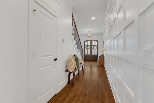 corridor with dark wood-type flooring and french doors