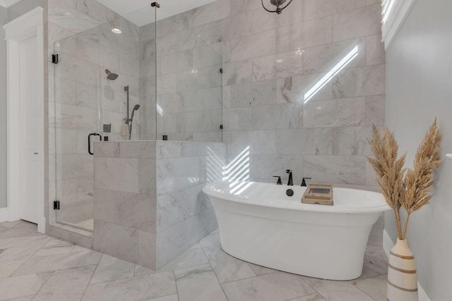 bathroom featuring tile walls and separate shower and tub