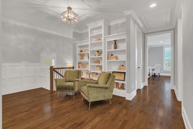 sitting room featuring crown molding, dark hardwood / wood-style floors, and built in shelves