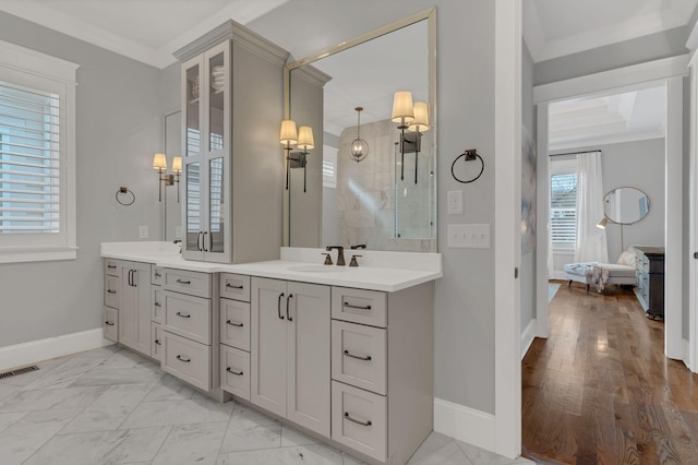 bathroom with crown molding and vanity