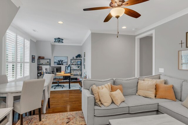 living room featuring ornamental molding, ceiling fan, and light hardwood / wood-style floors