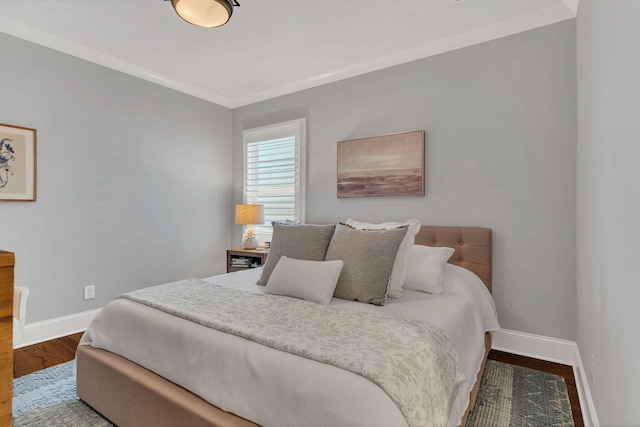 bedroom featuring wood-type flooring and ornamental molding