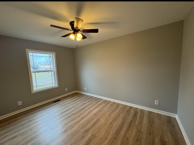 spare room with ceiling fan and light hardwood / wood-style flooring