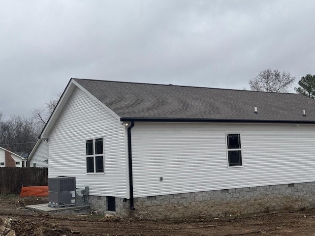 view of side of property with central AC unit