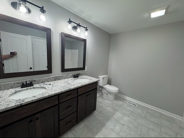 bathroom featuring vanity and toilet