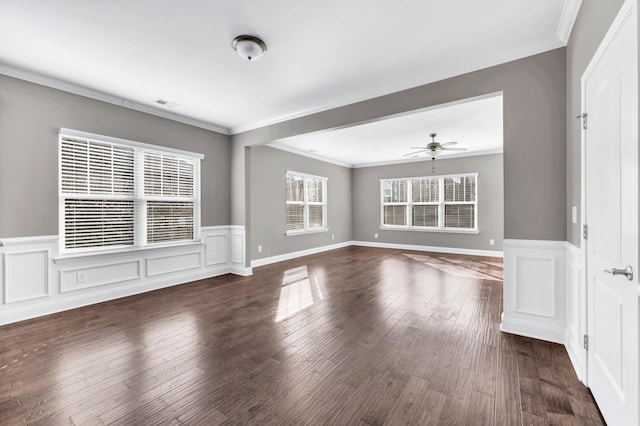 unfurnished living room featuring ceiling fan, ornamental molding, and dark hardwood / wood-style flooring