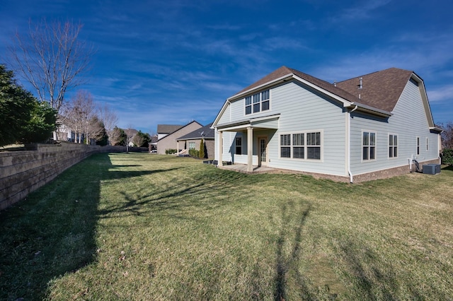 back of house with a lawn